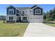 Two-story home with a gray and navy exterior, two-car garage, and a well-manicured front lawn at 245 Golfview Ave, Benson, NC 27504