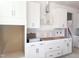 Kitchen featuring white cabinets, stainless steel hardware, and provision for modern appliances, still under construction at 245 Golfview Ave, Benson, NC 27504