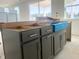 Kitchen island with gray cabinets, stylish hardware, and plenty of storage space under construction at 245 Golfview Ave, Benson, NC 27504