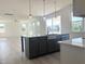 Modern kitchen island featuring dark cabinetry, light countertops, and stainless steel farmhouse sink at 245 Golfview Ave, Benson, NC 27504