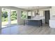 Modern kitchen with an island, stainless appliances, white cabinets, and hardwood floors at 245 Golfview Ave, Benson, NC 27504
