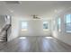 Spacious living room with a ceiling fan, hardwood floors, and large windows for natural light at 245 Golfview Ave, Benson, NC 27504