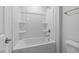 Bathroom featuring a standard tub and shower combination with modern fixtures and finishes at 2915 Huxley Way, Apex, NC 27502