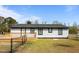 Single-story home with black trim and a wooden deck in the fenced-in backyard at 3005 Lewy Ln, Rocky Mount, NC 27801