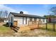 Single-story home showcasing a newly stained wooden deck and fenced-in yard at 3005 Lewy Ln, Rocky Mount, NC 27801