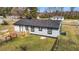 Single-story home with a wooden deck, fenced-in yard, and mature trees for shade at 3005 Lewy Ln, Rocky Mount, NC 27801