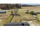 Aerial view of a spacious fenced backyard bordered by trees and open land at 3005 Lewy Ln, Rocky Mount, NC 27801
