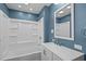 Modern bathroom features a bath and shower, updated vanity and mirror at 3005 Lewy Ln, Rocky Mount, NC 27801