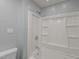 Bright bathroom featuring a shower and tub combination with sleek, white tiles at 3005 Lewy Ln, Rocky Mount, NC 27801