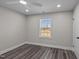 Cozy bedroom featuring a ceiling fan, modern flooring, and a window for natural light at 3005 Lewy Ln, Rocky Mount, NC 27801