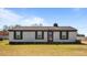 A quaint home with black accents, showcasing a well-maintained lawn and blooming flowers at 3005 Lewy Ln, Rocky Mount, NC 27801
