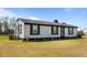 Charming one-story home with black shutters, landscaped yard, and an American flag at 3005 Lewy Ln, Rocky Mount, NC 27801