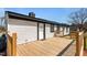 Charming single-story home with a newly stained wooden deck and black trim at 3005 Lewy Ln, Rocky Mount, NC 27801