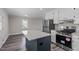 Bright kitchen features a center island, stainless steel appliances, and white cabinets for a modern look at 3005 Lewy Ln, Rocky Mount, NC 27801