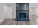 A living room with a blue brick fireplace and hardwood floors at 3005 Lewy Ln, Rocky Mount, NC 27801