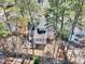 Aerial view shows backyard with patio nestled among mature trees and lush landscaping at 308 Burnt Pine Ct, Apex, NC 27502