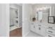 Bathroom with white cabinets and modern fixtures plus a laundry room in view at 308 Burnt Pine Ct, Apex, NC 27502