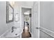 Small bathroom with white pedestal sink, mirror, and framed doorway to bedroom at 308 Burnt Pine Ct, Apex, NC 27502