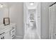 Bright bathroom with white cabinets, tile floors, and a window view at 308 Burnt Pine Ct, Apex, NC 27502