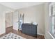 Bright bedroom features wood floors, gray dresser and blanket ladder at 308 Burnt Pine Ct, Apex, NC 27502