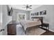 Cozy bedroom featuring a ceiling fan, queen bed, and dark wood furniture at 308 Burnt Pine Ct, Apex, NC 27502