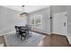 Dining room with a modern light fixture, a dining table and a window view of the outdoors at 308 Burnt Pine Ct, Apex, NC 27502