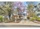 Charming home featuring a welcoming front porch, a one-car garage and well-manicured front yard at 308 Burnt Pine Ct, Apex, NC 27502