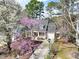Aerial view of a charming home with a blooming tree and a long driveway at 308 Burnt Pine Ct, Apex, NC 27502