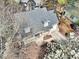 An aerial shot showcases a charming home with a covered porch and a driveway leading to the garage at 308 Burnt Pine Ct, Apex, NC 27502