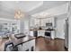 Bright kitchen with white cabinets, stainless steel appliances, and a dark wood floor at 308 Burnt Pine Ct, Apex, NC 27502