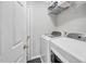 Well-lit laundry room featuring a washer, dryer, and ample shelving at 308 Burnt Pine Ct, Apex, NC 27502
