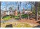 Spacious backyard view featuring beautiful landscaping and surrounding homes at 3207 Coachmans Way, Durham, NC 27705