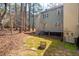 Backyard with mature trees, providing privacy, featuring a deck and well-maintained lawn at 3207 Coachmans Way, Durham, NC 27705
