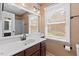 Bright bathroom features a large vanity, mirror, and a window with natural light at 3207 Coachmans Way, Durham, NC 27705