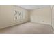 Bright, carpeted bedroom features a large window and closet space; ample natural light at 3207 Coachmans Way, Durham, NC 27705