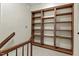 A landing features large, beautiful wood built-in shelving for storage and display at 3207 Coachmans Way, Durham, NC 27705