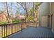 Exterior deck with gray floor overlooking lush backyard and treeline at 3207 Coachmans Way, Durham, NC 27705