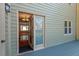 View from deck to living area with wood floors and modern chandelier at 3207 Coachmans Way, Durham, NC 27705