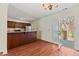 Open dining area featuring hardwood floors, a modern chandelier and sliding door to deck at 3207 Coachmans Way, Durham, NC 27705