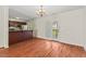 Open dining area featuring hardwood floors, a modern chandelier and sliding door to deck at 3207 Coachmans Way, Durham, NC 27705