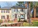 Charming townhome with green siding, brown shutters, brick steps, and mature trees at 3207 Coachmans Way, Durham, NC 27705
