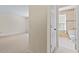 Bright hallway view leading to a bathroom with patterned wallpaper and a sunny window at 3207 Coachmans Way, Durham, NC 27705