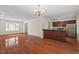 Open living area with a breakfast bar, hardwood floors, and a view into the kitchen at 3207 Coachmans Way, Durham, NC 27705