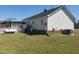 View of the side and back of the house, including a deck, lawn, and utilities at 3226 Powhatan Rd, Clayton, NC 27527