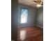 Comfortable bedroom featuring hardwood floors, window and ceiling fan at 3226 Powhatan Rd, Clayton, NC 27527