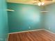 Bedroom featuring hardwood floors, two shelves and ceiling fan at 3226 Powhatan Rd, Clayton, NC 27527