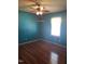 Bedroom features hardwood floors, a ceiling fan and window at 3226 Powhatan Rd, Clayton, NC 27527