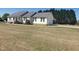 Charming single-story home with attached garage, well-manicured lawn, and mature trees at 3226 Powhatan Rd, Clayton, NC 27527