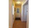 Hallway with hardwood flooring and white doors leading to other rooms and spaces at 3226 Powhatan Rd, Clayton, NC 27527