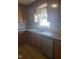 Kitchen with stainless steel sink, wooden cabinets, laminate counters and tile backsplash at 3226 Powhatan Rd, Clayton, NC 27527